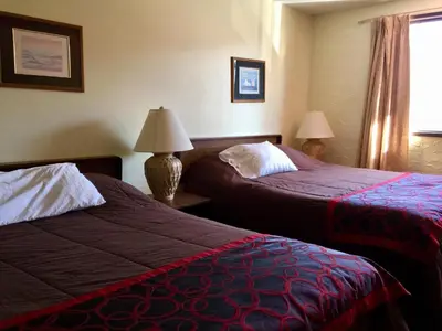 a hotel room with two beds and a window at Villagers Inn in Fruitvale