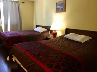 a hotel room with two beds and a lamp at Villagers Inn in Fruitvale