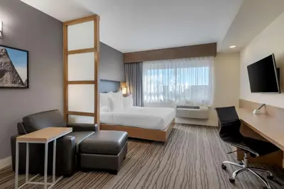 a hotel room with a bed and a desk at Best Western Plus Sawridge Suites in Fort McMurray