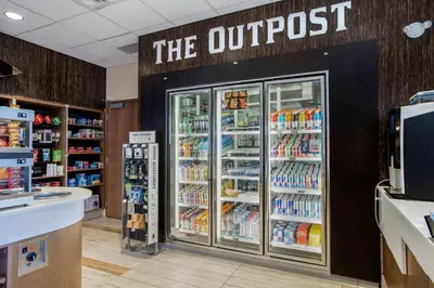 a store with a grocery store with the outbreak sign on the wall at Best Western Plus Sawridge Suites in Fort McMurray