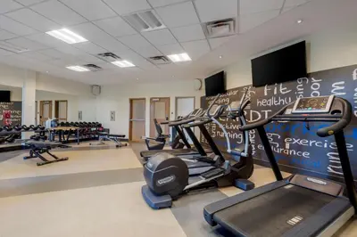 a gym with rows of treadmills and machines at Best Western Plus Sawridge Suites in Fort McMurray