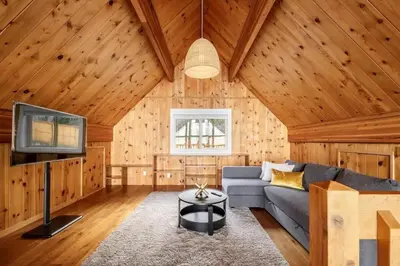 a living room with a couch and a tv at Ocean's Embrace Suite in Nanaimo