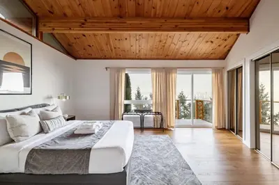 a bedroom with a large bed with a wooden ceiling at Ocean's Embrace Suite in Nanaimo