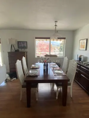 a dining room table with white chairs around it at Mountain View Villa with Saltwater Pool in Oliver