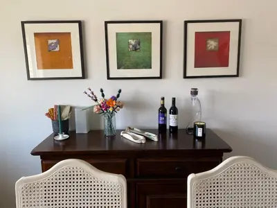 a table with two bottles of wine and two chairs at Mountain View Villa with Saltwater Pool in Oliver