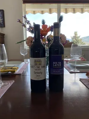 two bottles of wine sitting on top of a table at Mountain View Villa with Saltwater Pool in Oliver