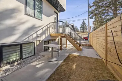 a house with a staircase in front of a building at Ultimate Group Stay, 3 King Beds, 2 Suites in Calgary