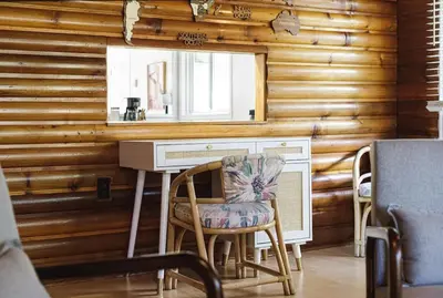 a desk and chair in a room with a mirror at Sylvan Cabin - 3 BR Family Fun Luxurious Yard in Sylvan Lake