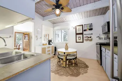 a kitchen with a sink and a ceiling fan at Sylvan Cabin - 3 BR Family Fun Luxurious Yard in Sylvan Lake