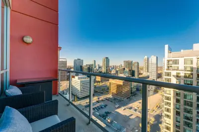 a balcony with a view of a city at 2 Storey Penthouse Panoramic Views Parking Stampede in Calgary