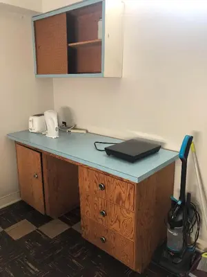 a desk with a laptop on top of it at Comfort cottage guest home near subway station, bus and downtown in Vancouver