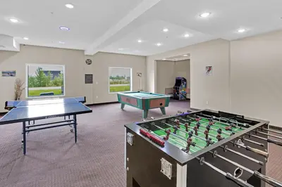 a room with two ping pong tables in it at Duvernay Inn & Suites in Fox Creek