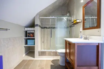 a bathroom with a shower and a sink and a toilet at Calgary - By Mountains and Ski in Calgary