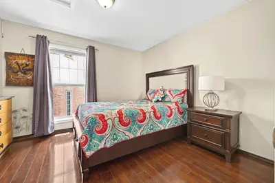 a bedroom with a bed and a dresser and a window at Calgary - By Mountains and Ski in Calgary