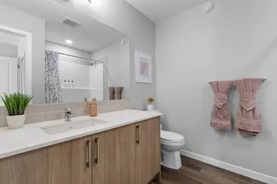 a bathroom with a sink and a toilet at Relax in Comfort, AC, YYC, CrossIron Mills, Banff in Calgary