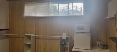 a kitchen with a small refrigerator and a microwave at WhiteCourt in Abbotsford