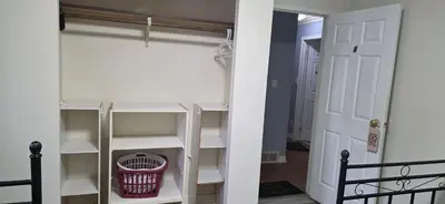 a closet with white shelves and a door at WhiteCourt in Abbotsford