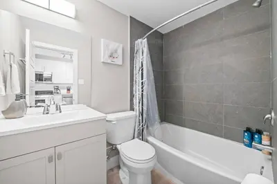 a bathroom with a sink and a toilet and a tub at Boutique-Style Studio Unit in Edmonton