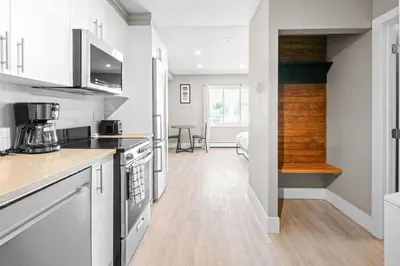a kitchen with white cabinets and a counter top at Boutique-Style Studio Unit in Edmonton