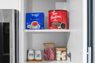 a shelf in a refrigerator filled with food and drinks at Boutique-Style Studio Unit in Edmonton