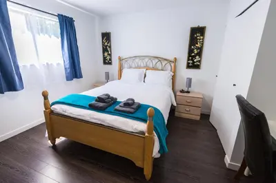 a bedroom with a bed with towels on it at Bright & Spacious House Near UBC in Vancouver