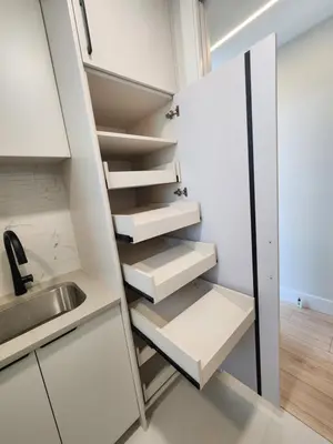 a small kitchen with white cabinets and a sink at Luxury 3-Bedroom Home Modern Retreat in Vancouver in Vancouver