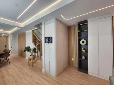 a living room with white walls and wooden floors at Luxury 3-Bedroom Home Modern Retreat in Vancouver in Vancouver
