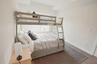 a bedroom with a bunk bed with white walls at New Vaulted Ceilings 3 Beds AC Views in Golden
