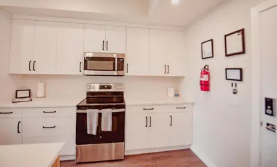 a kitchen with white cabinets and a microwave at New Vaulted Ceilings 3 Beds AC Views in Golden