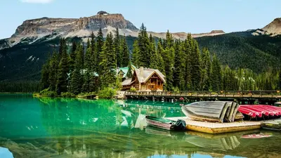 a lake with a house and boats on the dock at New Vaulted Ceilings 3 Beds AC Views in Golden