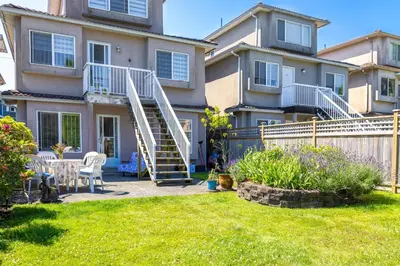 a house with a spiral staircase in a yard at 2 Bds suite beautiful Yard near PNE in Vancouver