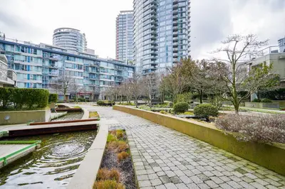 a walkway in a city with tall buildings at Gorgeous Unit with City Views in Vancouver