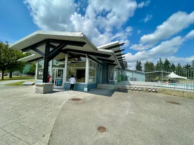 a woman is standing in front of a building at Top choice 2-Bed 1-Bath Garden Suite in New Westminster
