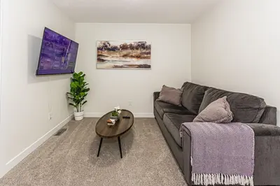 a living room with a couch and a table at Escape in Style, River Cree, Netflix, Near WEM in Edmonton