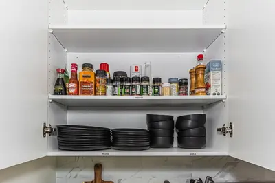 a cupboard filled with plates and other dishes at Escape in Style, River Cree, Netflix, Near WEM in Edmonton