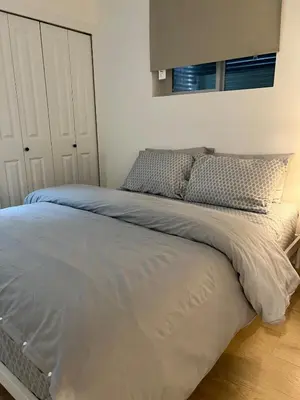 a large bed in a bedroom with at Modern 2bd suite near Langley Events Centre in Langley
