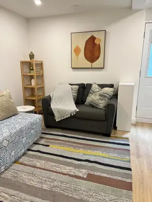 a living room with a couch and a rug at Modern 2bd suite near Langley Events Centre in Langley