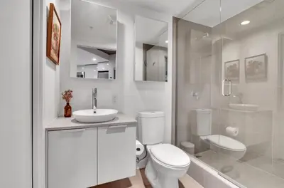 a bathroom with a toilet and a sink and a shower at Modern Downtown Stay! in Vancouver