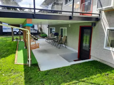 a porch of a house with a deck and a patio at Gordon Head Bed & Breakfast 2 Bathroom 4TV 5 Beds, Private Yard, Kids Gym & Games, Breakfast, WorkStn, Laundry, Kitchen in Victoria
