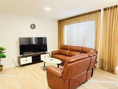 a living room with a couch and a television at Relax at The Hills at Ellerslie in Edmonton