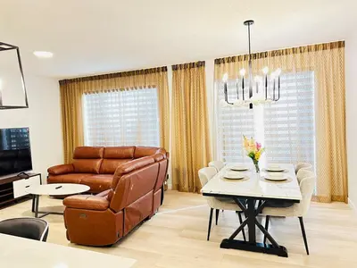a living room with a couch and a table at Relax at The Hills at Ellerslie in Edmonton
