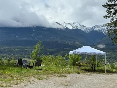 two chairs and a picnic table under a white tent at Uncle Bills Cabin Entire home 6 min south of town in Golden