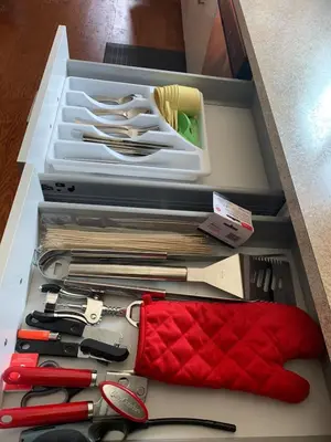 a drawer filled with lots of knives and scissors at Uncle Bills Cabin Entire home 6 min south of town in Golden