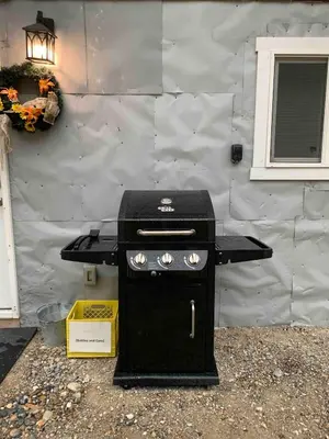 a black grill sitting in front of a building at Uncle Bills Cabin Entire home 6 min south of town in Golden