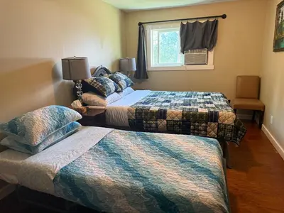 a hotel room with two beds and a window at Uncle Bills Cabin Entire home 6 min south of town in Golden