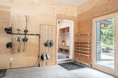 a room with a pivot door and a room with shoes at Camozzi Chalet by Revelstoke Vacations in Revelstoke