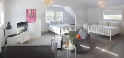 a living room with a bed and a couch at Fieldstone Guesthouse in Clearwater