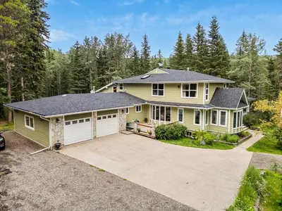 a large yellow house with a garage at Freele Escape Secluded Nature Haven Sleeps 17 in Priddis