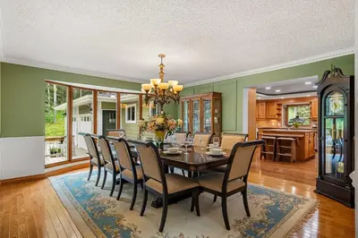 a dining room with a table and chairs at Freele Escape Secluded Nature Haven Sleeps 17 in Priddis
