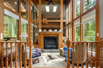 a living room with a fireplace in a house at Freele Escape Secluded Nature Haven Sleeps 17 in Priddis